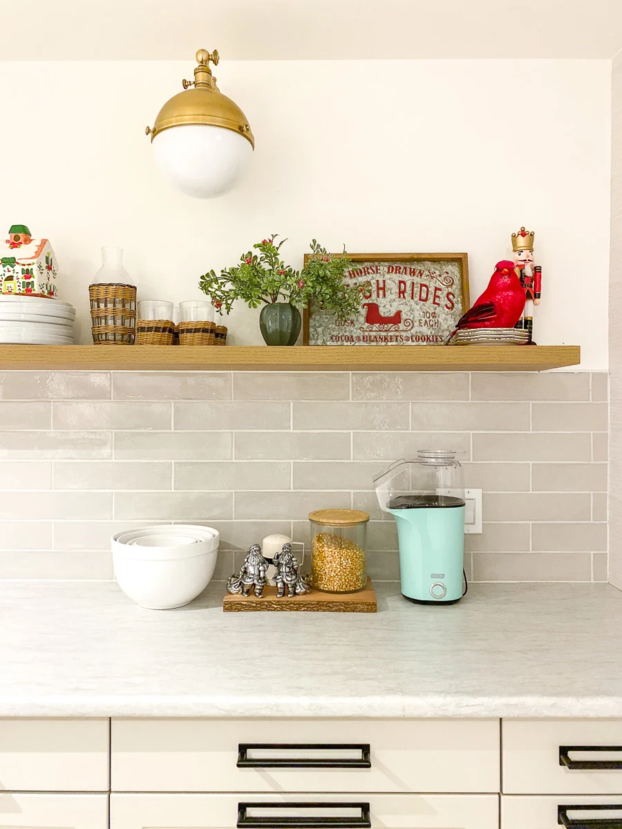 basement kitchenette with peg rail, farmhouse sink, and floating shef