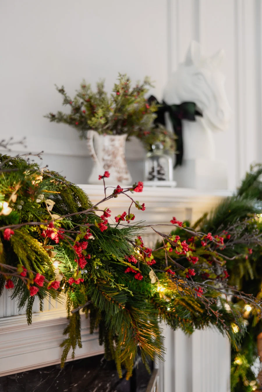 traditional christmas mantel decor with faux garland, mirror, berry vine garland