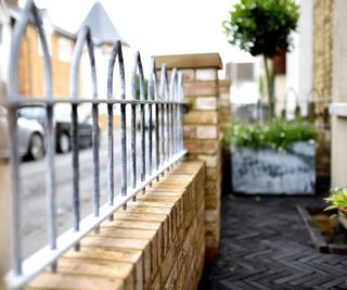 brick wall and railings in front garden