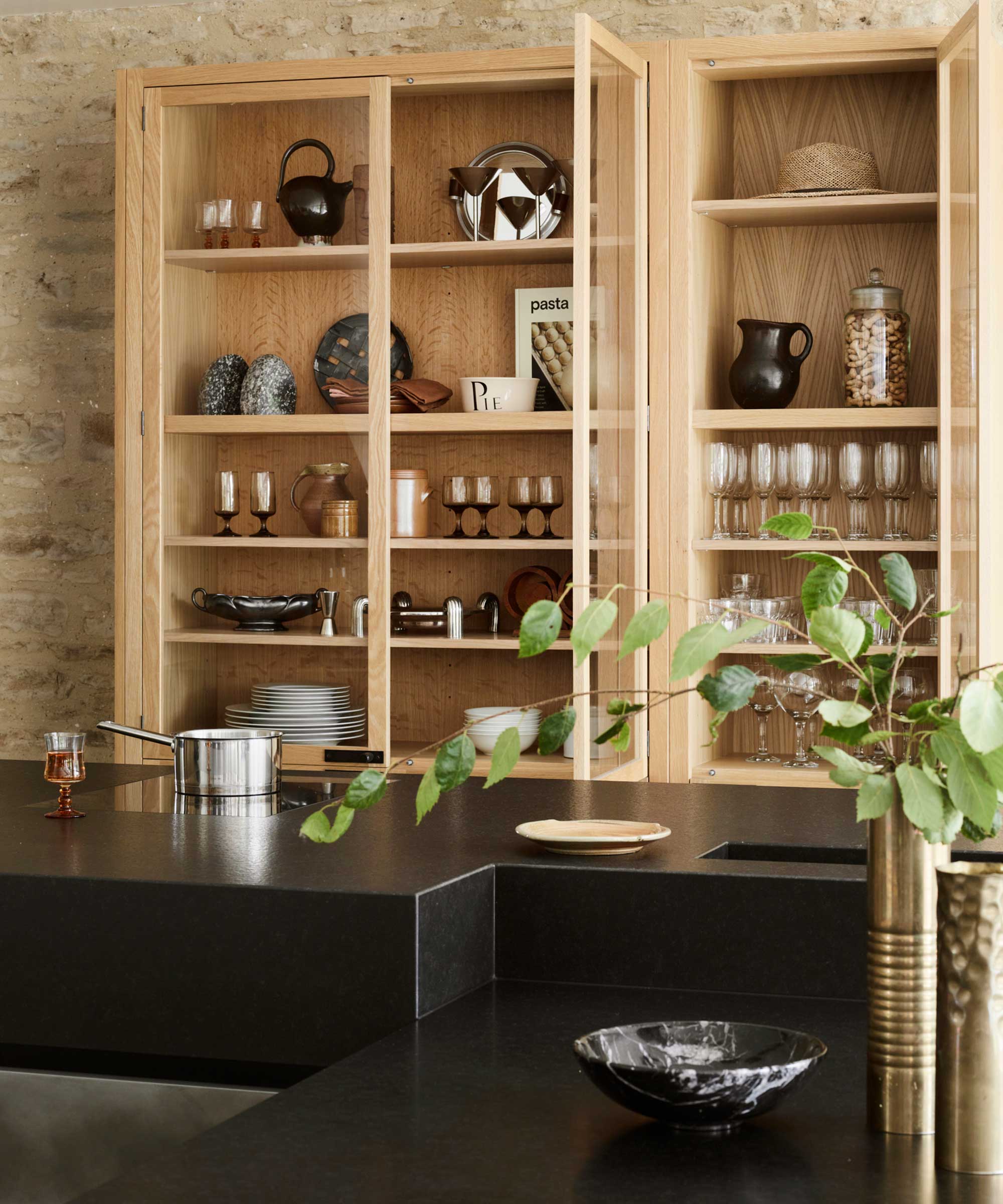 large bespoke storage unit with glazed doors in a kitchen