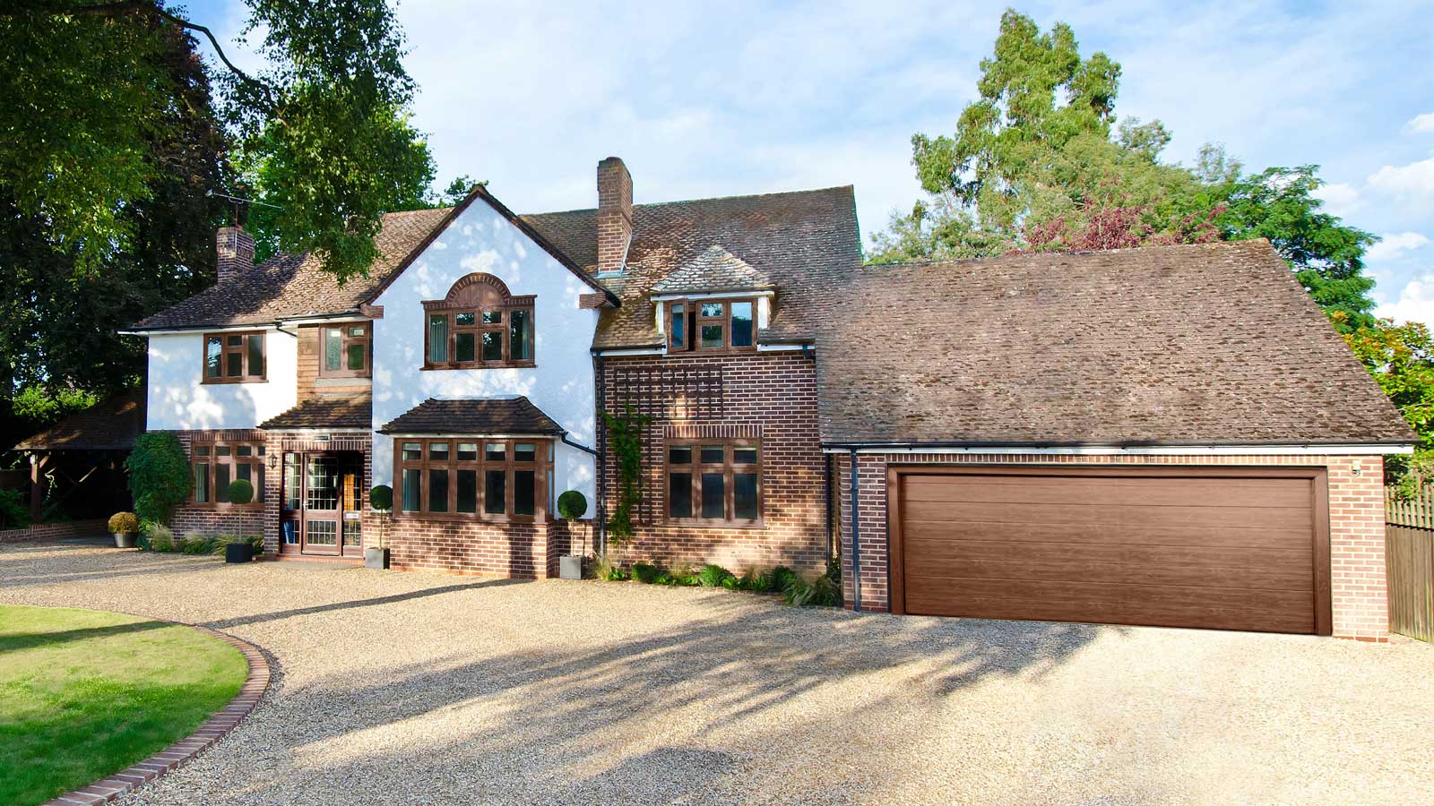 large detached house with attached garage with brown garage door