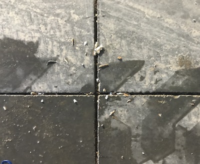 Ravelled concrete joint edges from late sawcut timing.