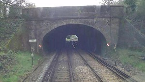 Three track workers take evasive action in tunnel to avoid train