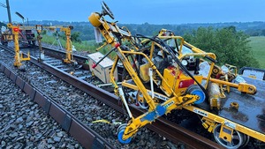 A yellow track trolley on a track that