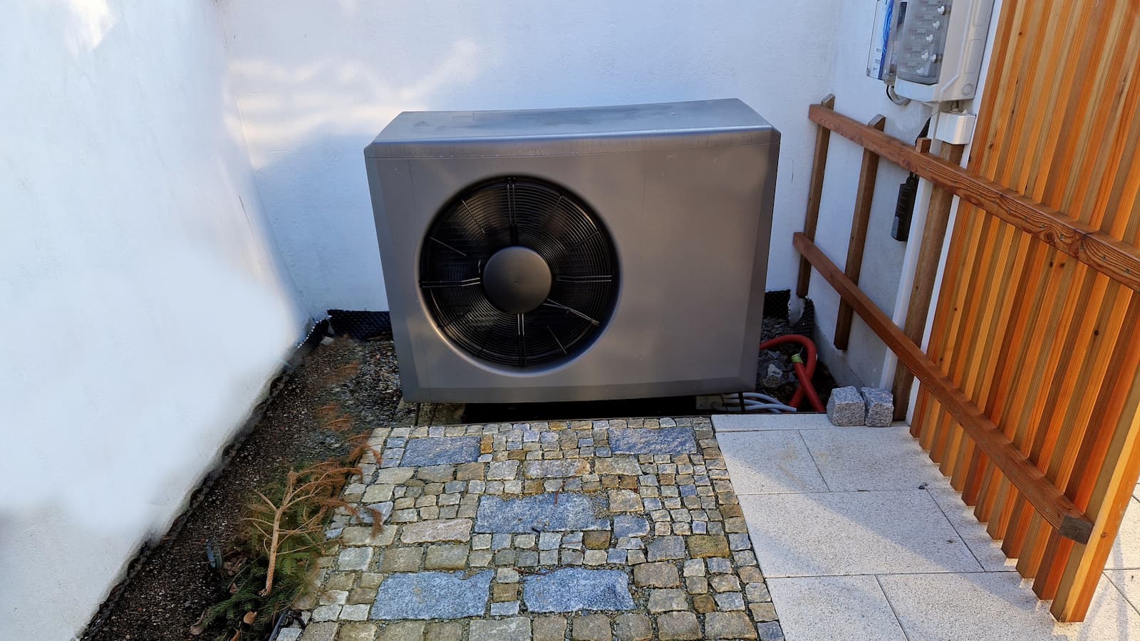 A heat pump hidden behind a fence