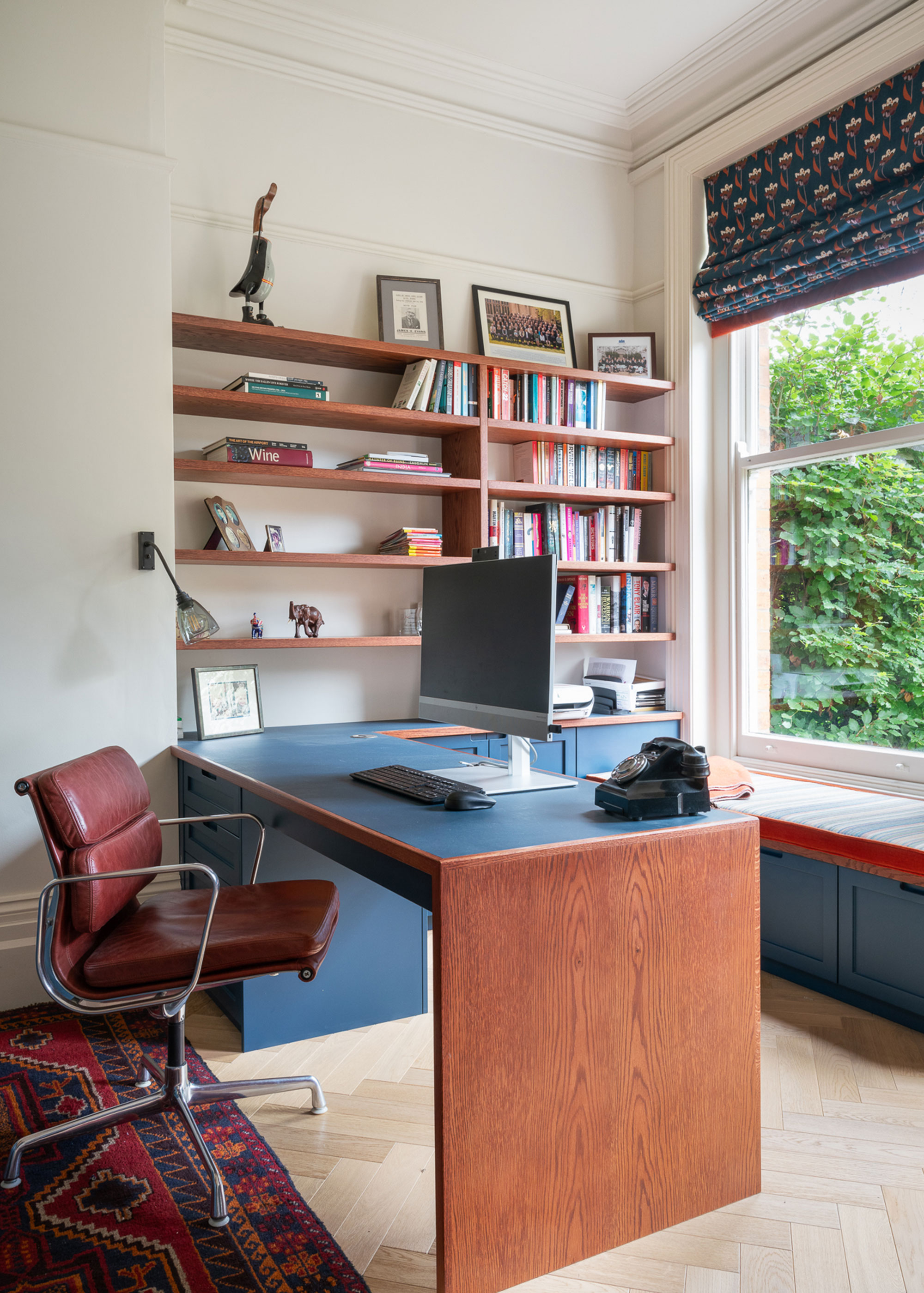 home office with herringbone flooring and window seat