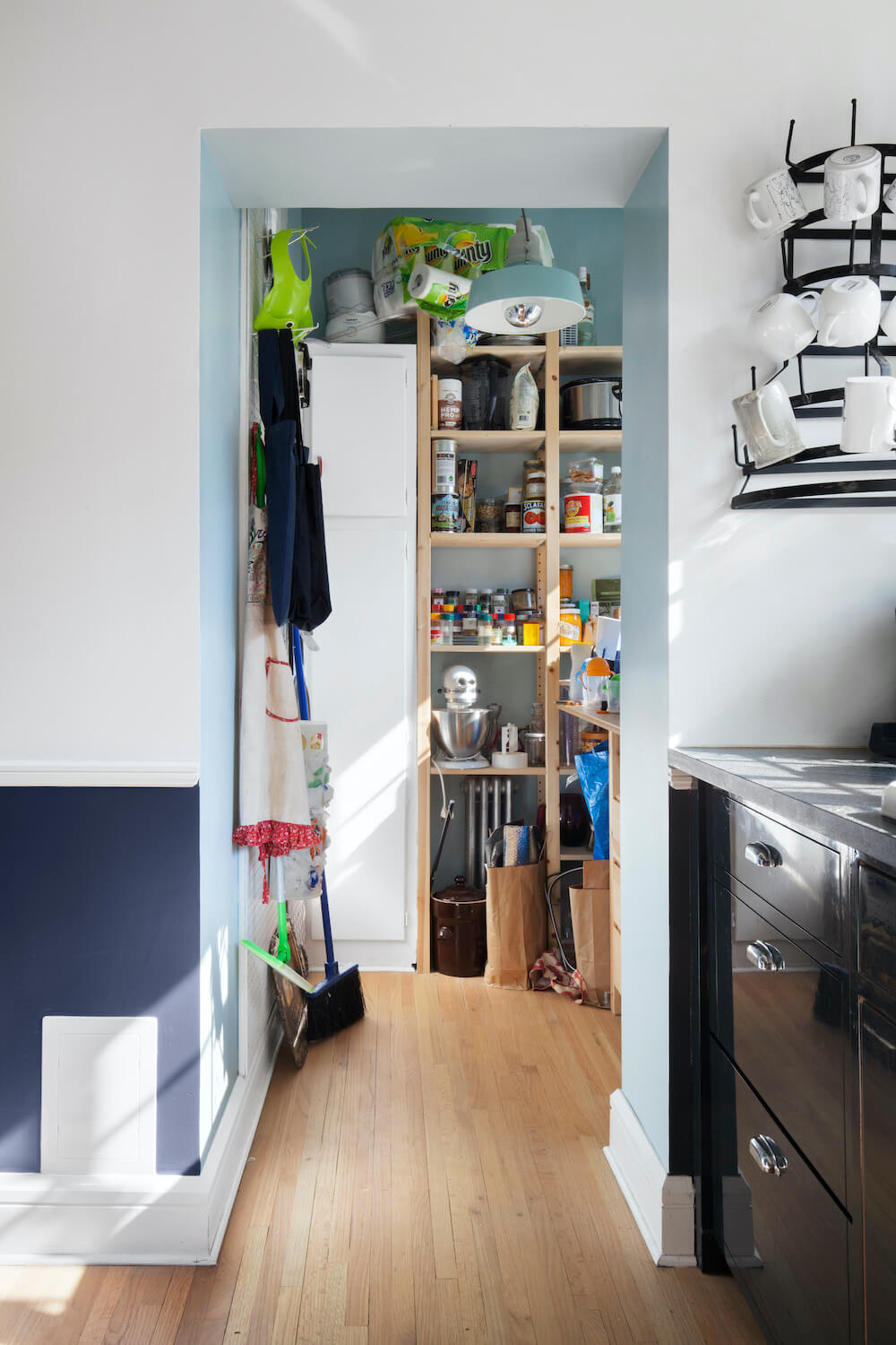 Black kitchen cabinets and view of the dry pantry area after renovation
