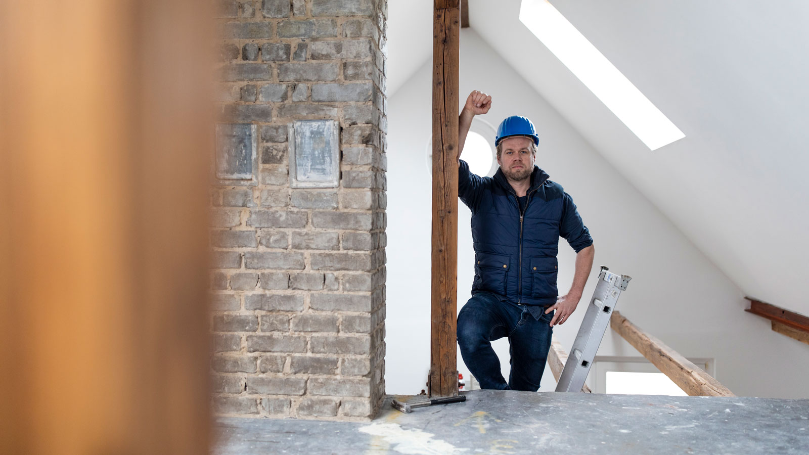 builder standing at the entrance of loft conversion project