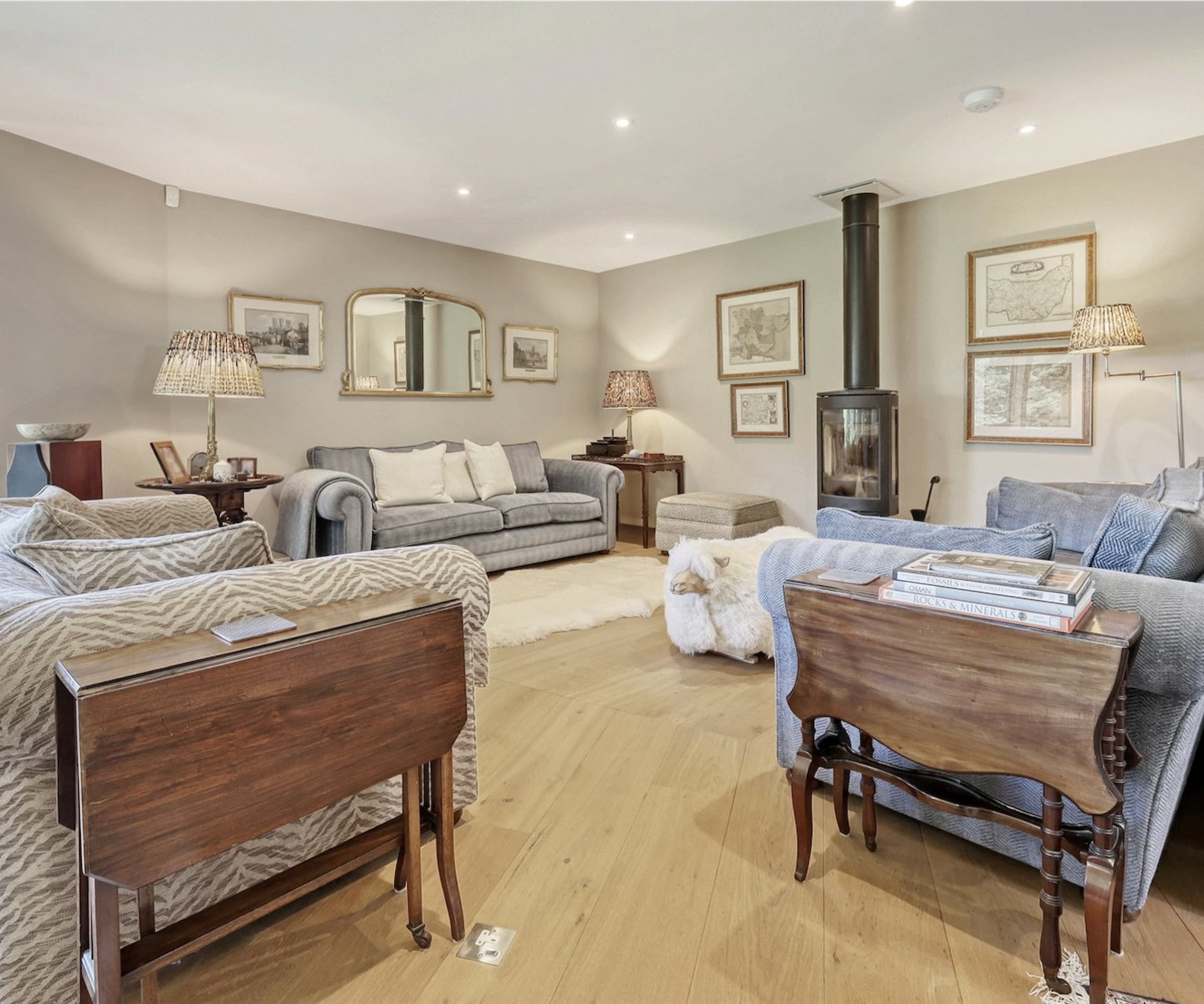 A living room with woodburner going to the ceiling