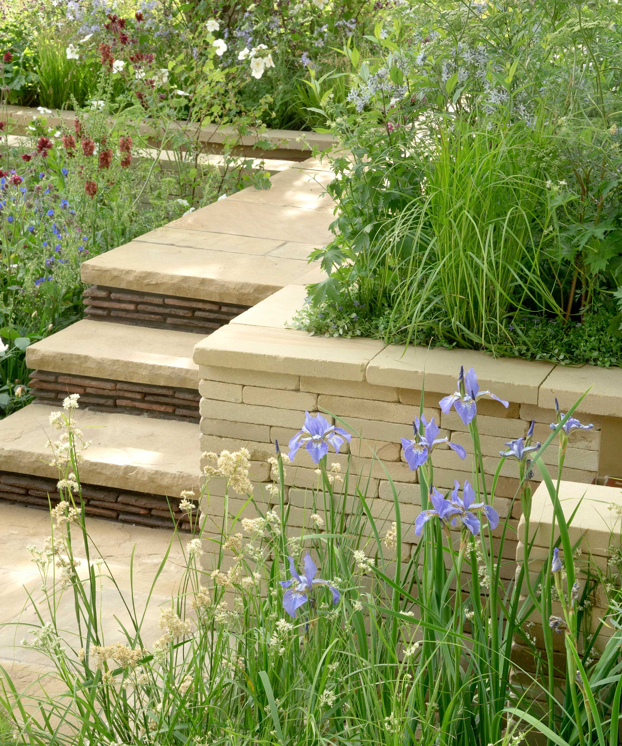 paved steps and a retaining wall in a garden at the Chelsea Flower Show