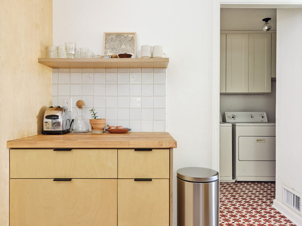 small breakfast station with storage and backsplash near laundry room after renovation