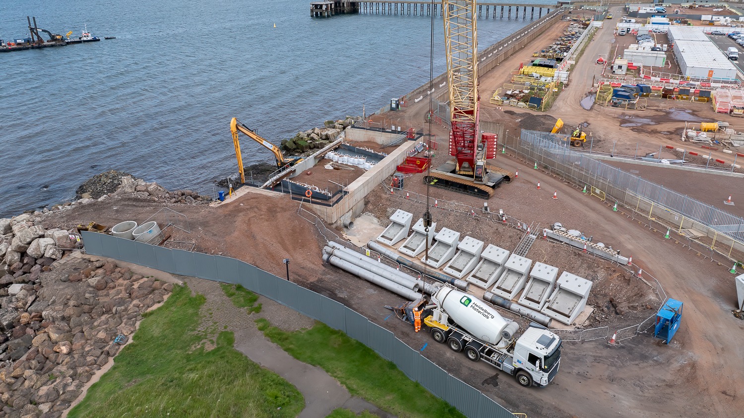 A construction site next to the sea with. There