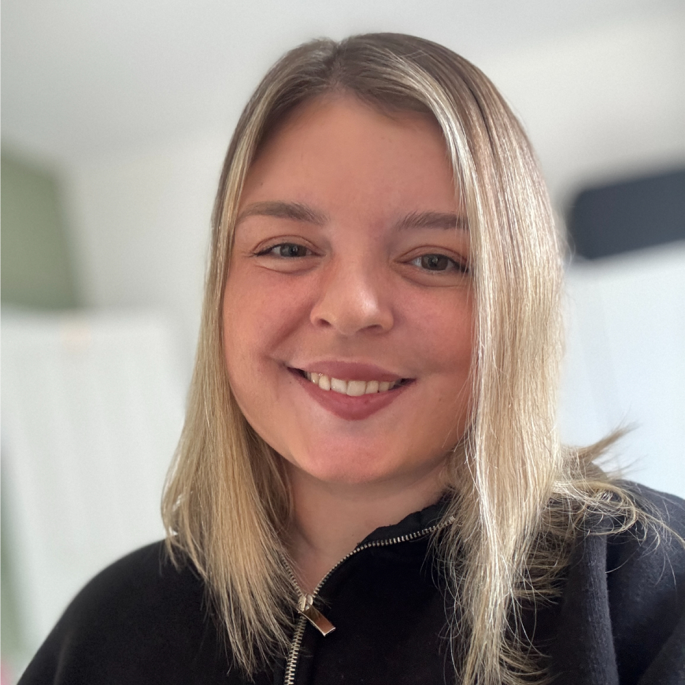 female with shoulder length blonde hair smiling
