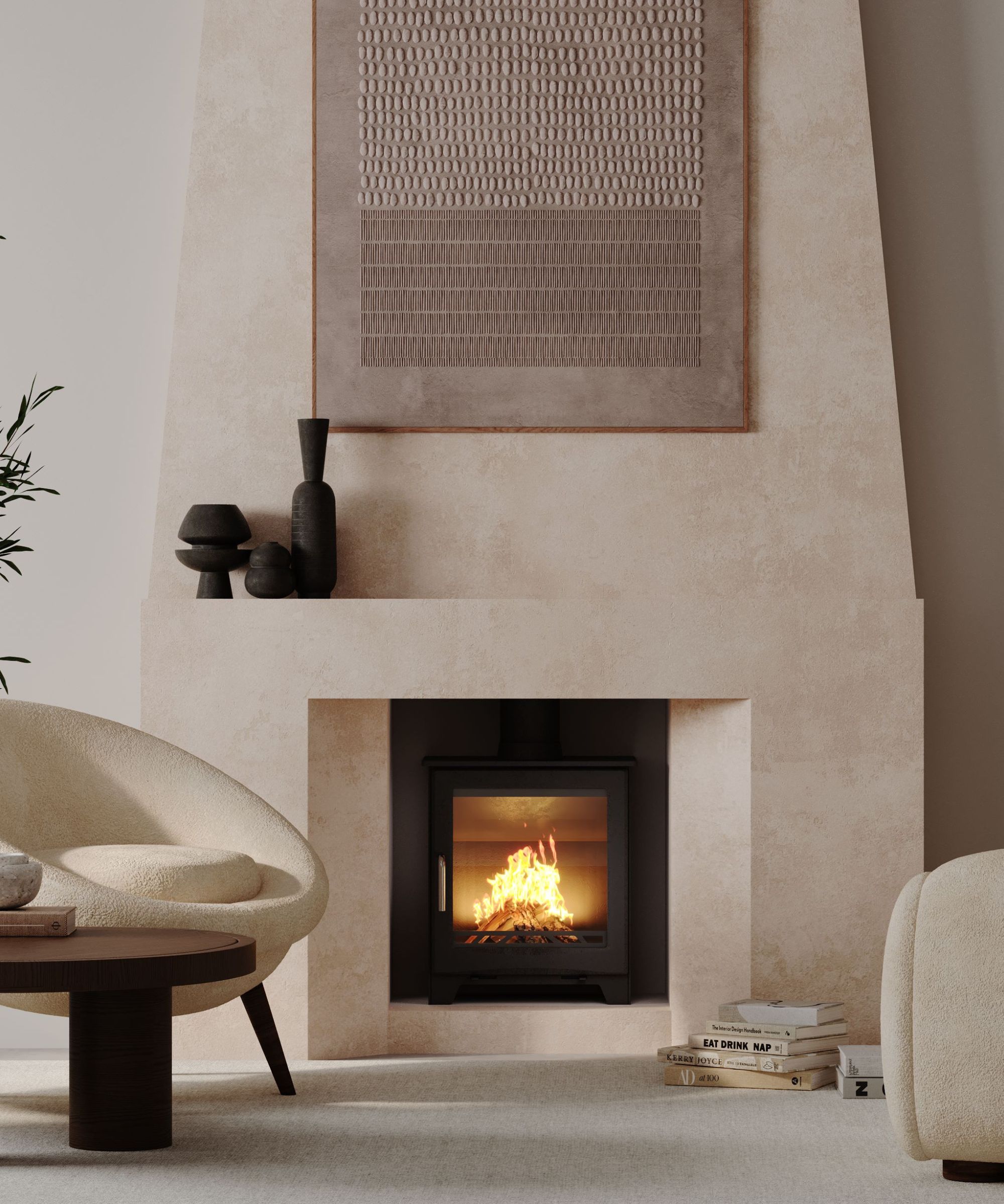 A modern black log burner with vivid flames is set against a terrazzo-tiled fireplace surround. A light wood mantel rests above, with an autumnal wreath of leaves, berries, and pinecones hanging on the wall above it.