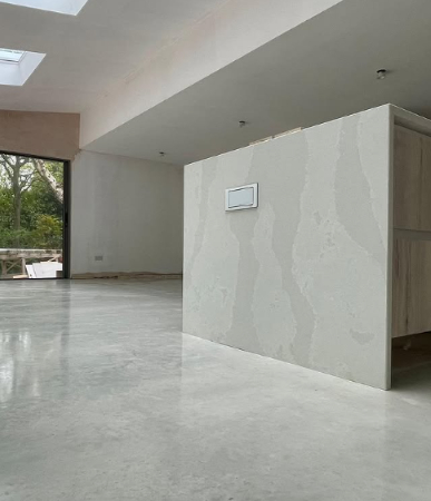 Examples of polished concrete and microcement floors. The polished concrete is shiny while the microcement is more textured