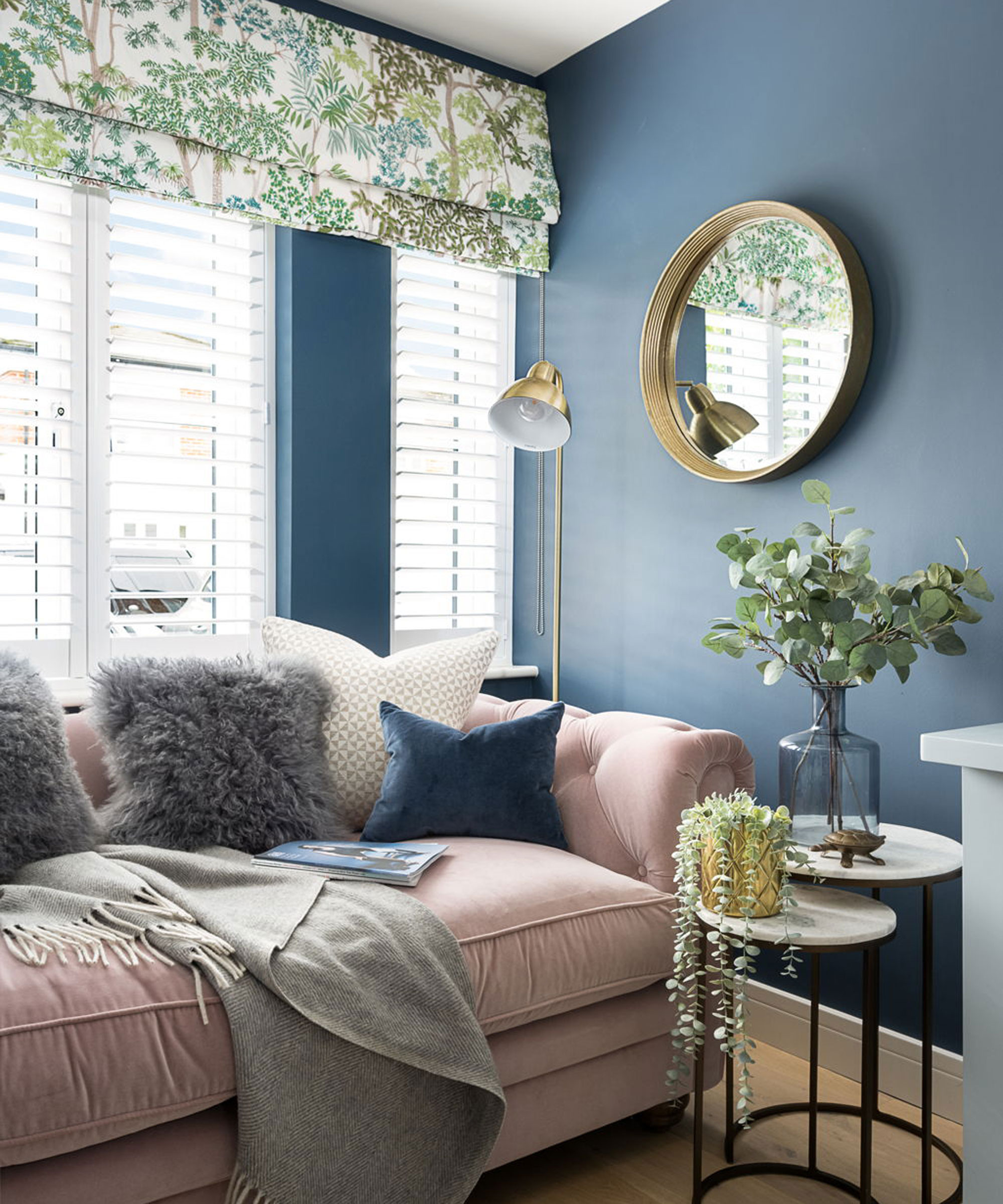 blue living room with pastel pink velvet sofa