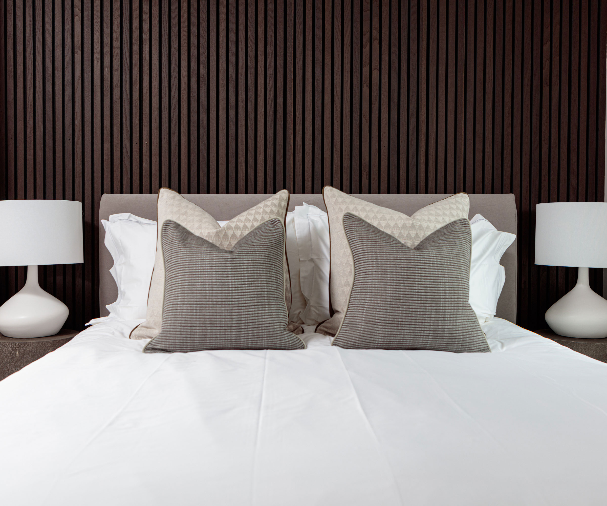 dark wood narrow vertical wall panelling in a modern bedroom