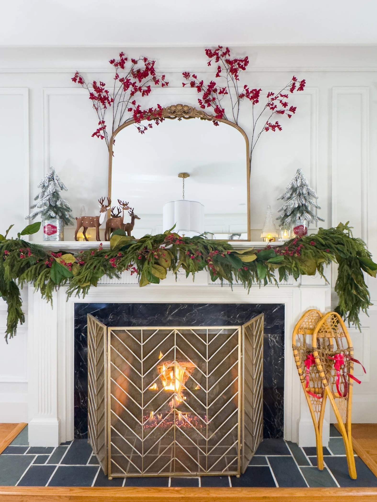 traditional fireplace mantel with garland mirror and red accents