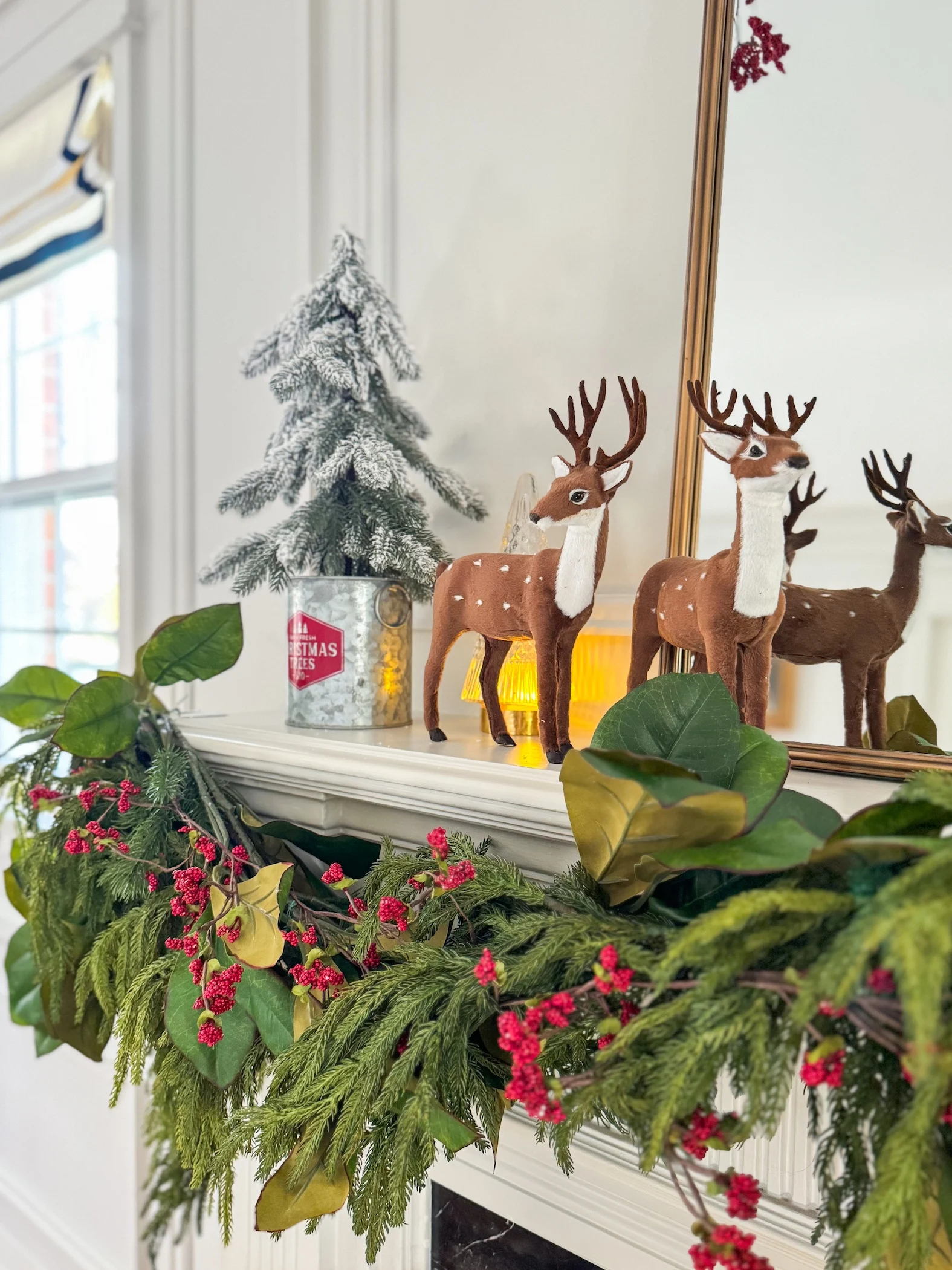 traditional fireplace mantel with garland mirror and red accents