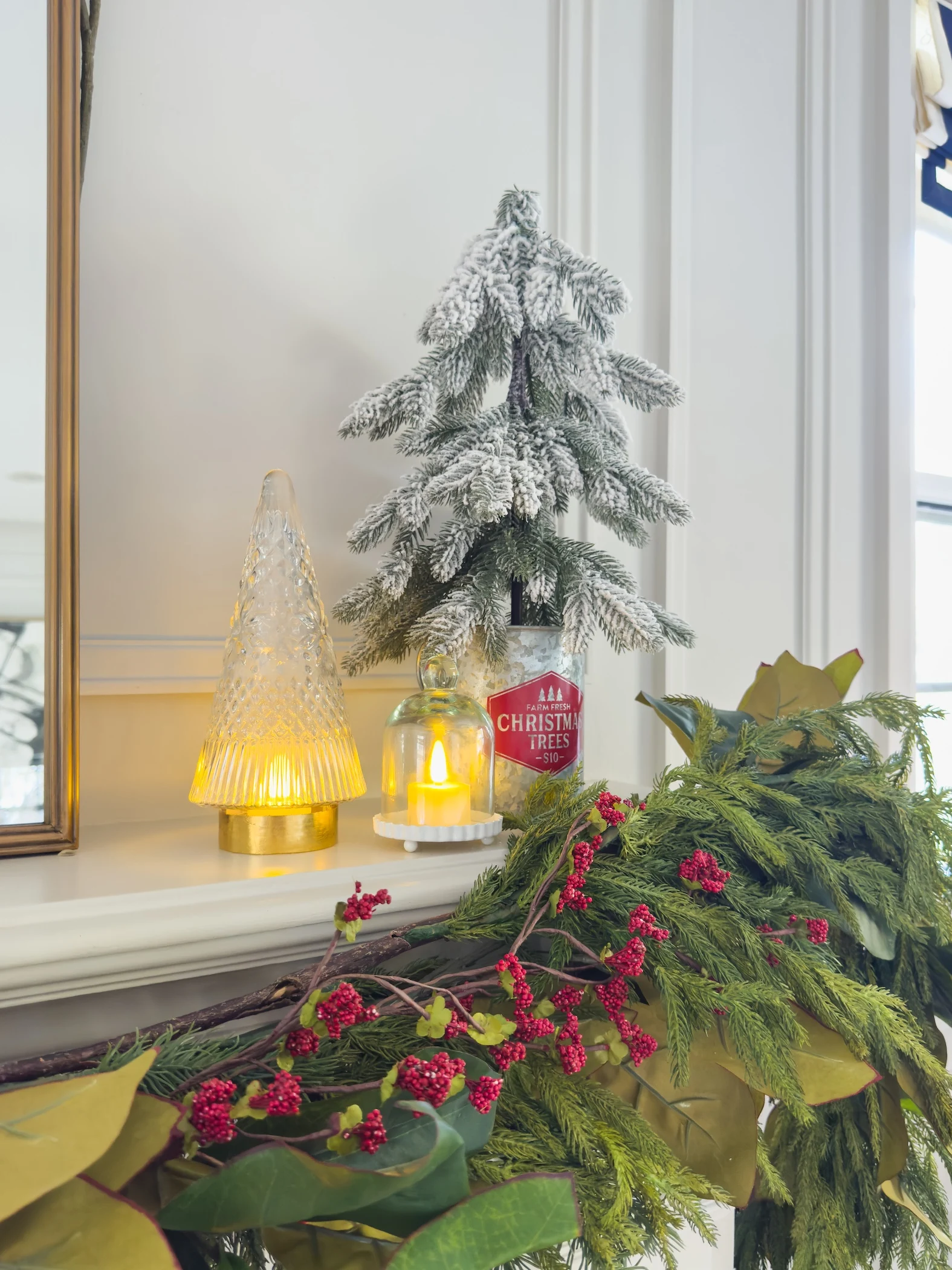 traditional fireplace mantel with garland mirror and red accents