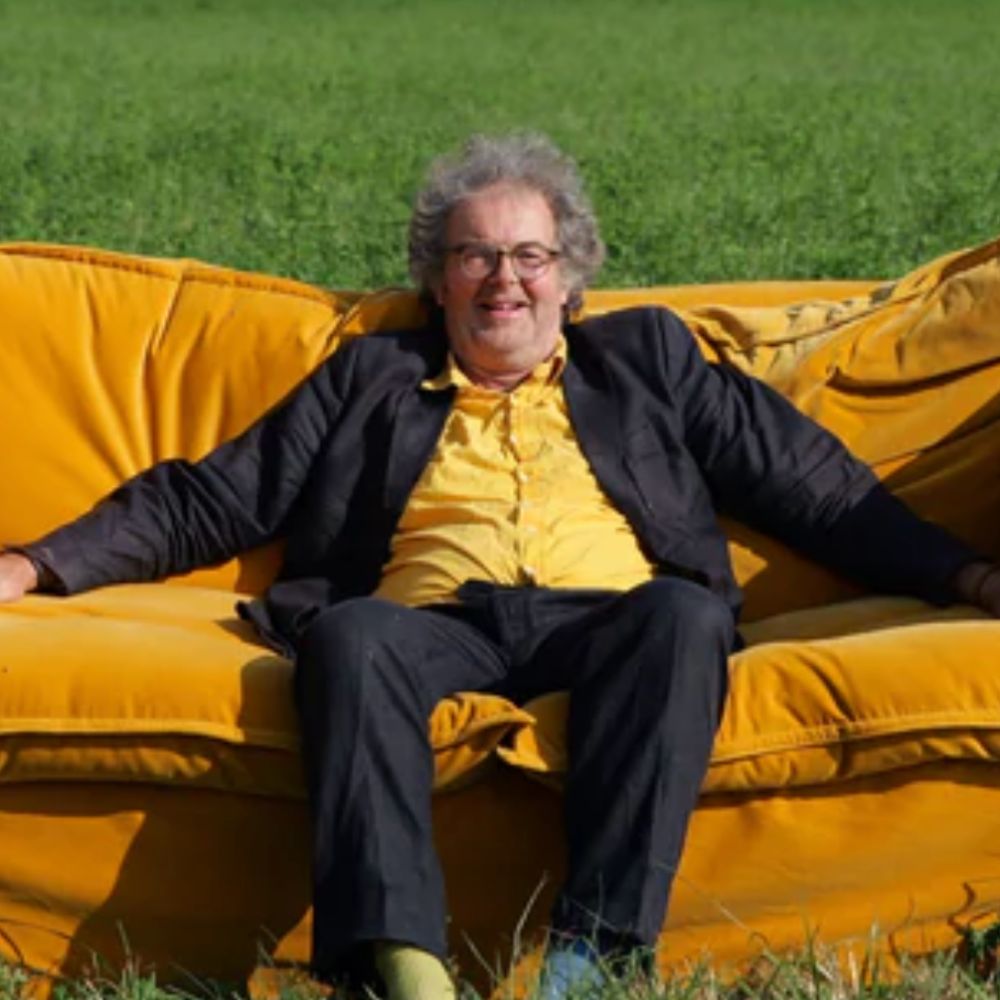 Schplendid's founder sat on a yellow sofa