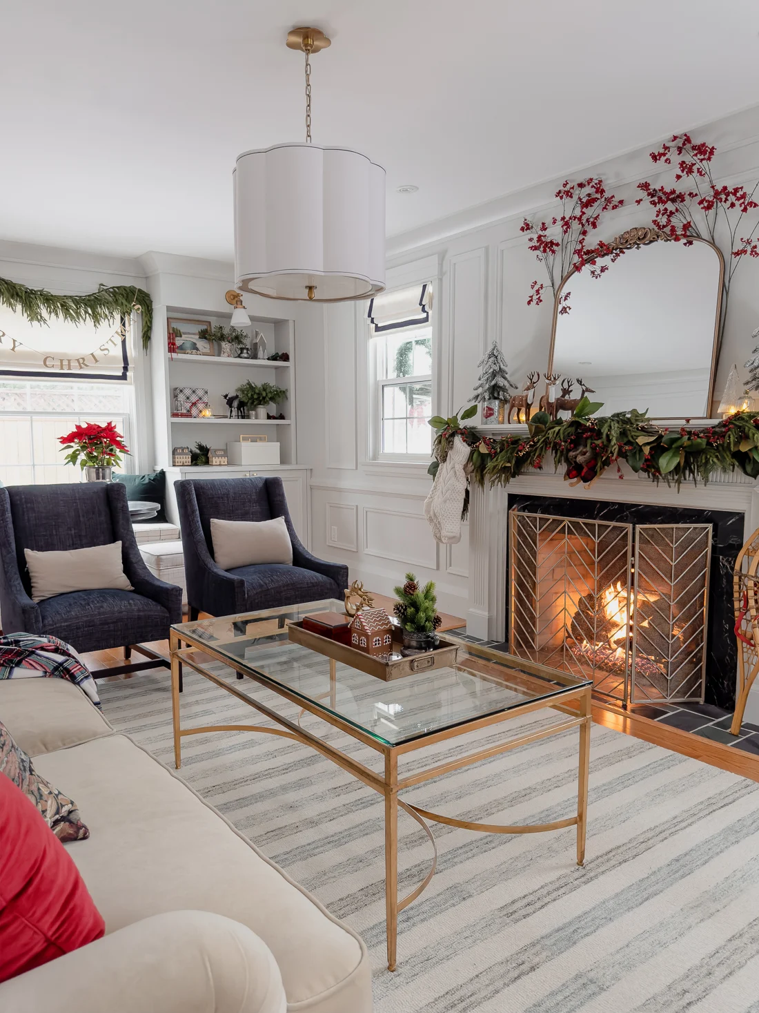 traditional red and green christmas decor, classic christmas living room decorations, cozy living room for the holidays classic traditional living room, fireplace mantel garland, striped neutral rug