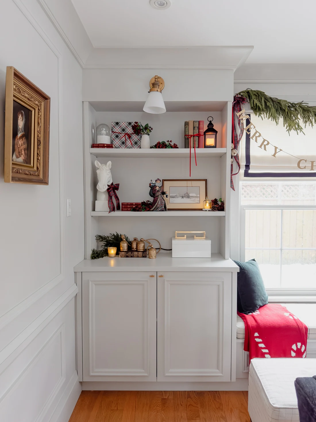 traditional red and green christmas decor, classic christmas living room decorations, cozy living room for the holidays classic traditional living room, built in window seat and bookcases, red and green decorations