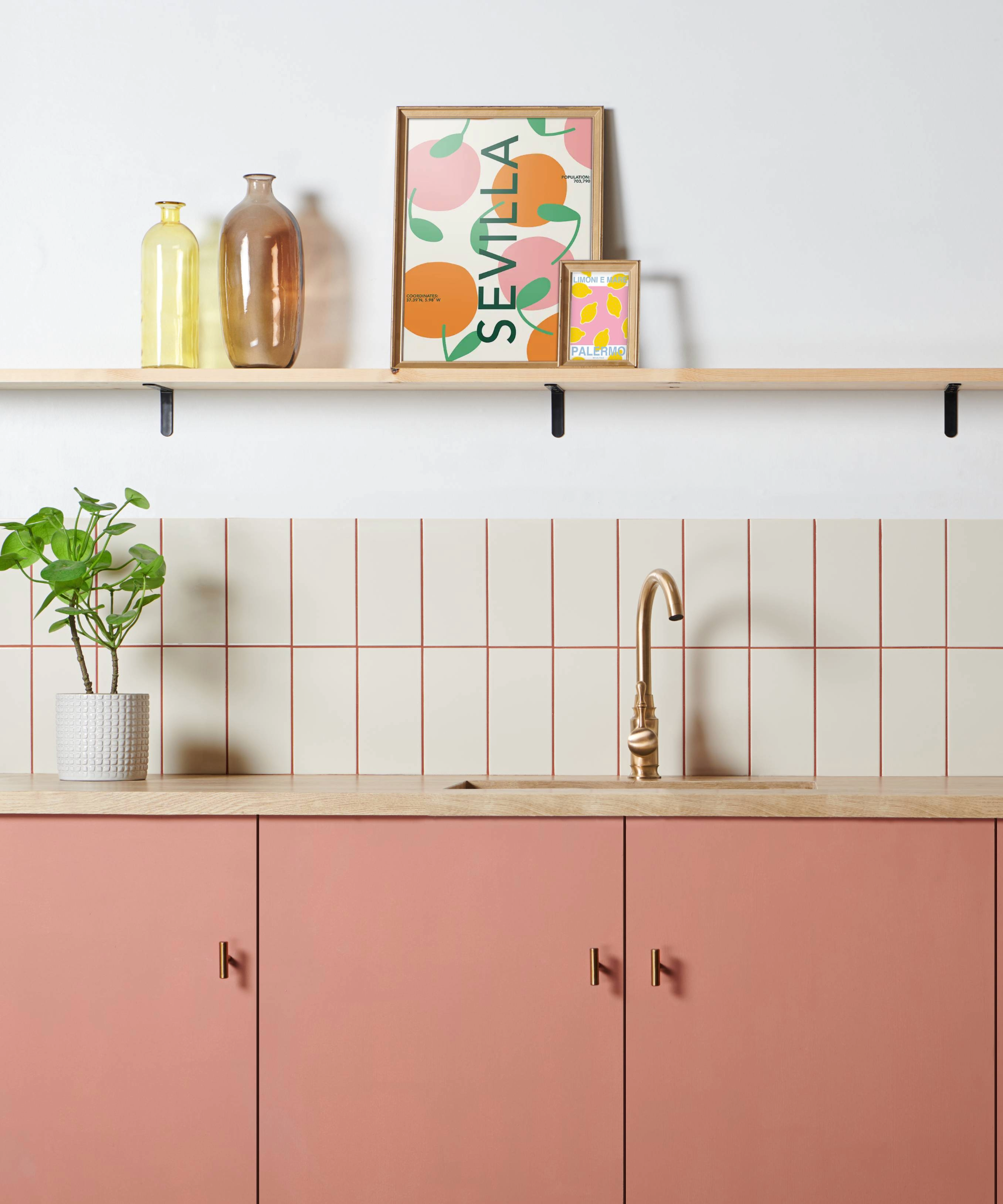 Kitchen with pink cabinets, white tiles and pink grout