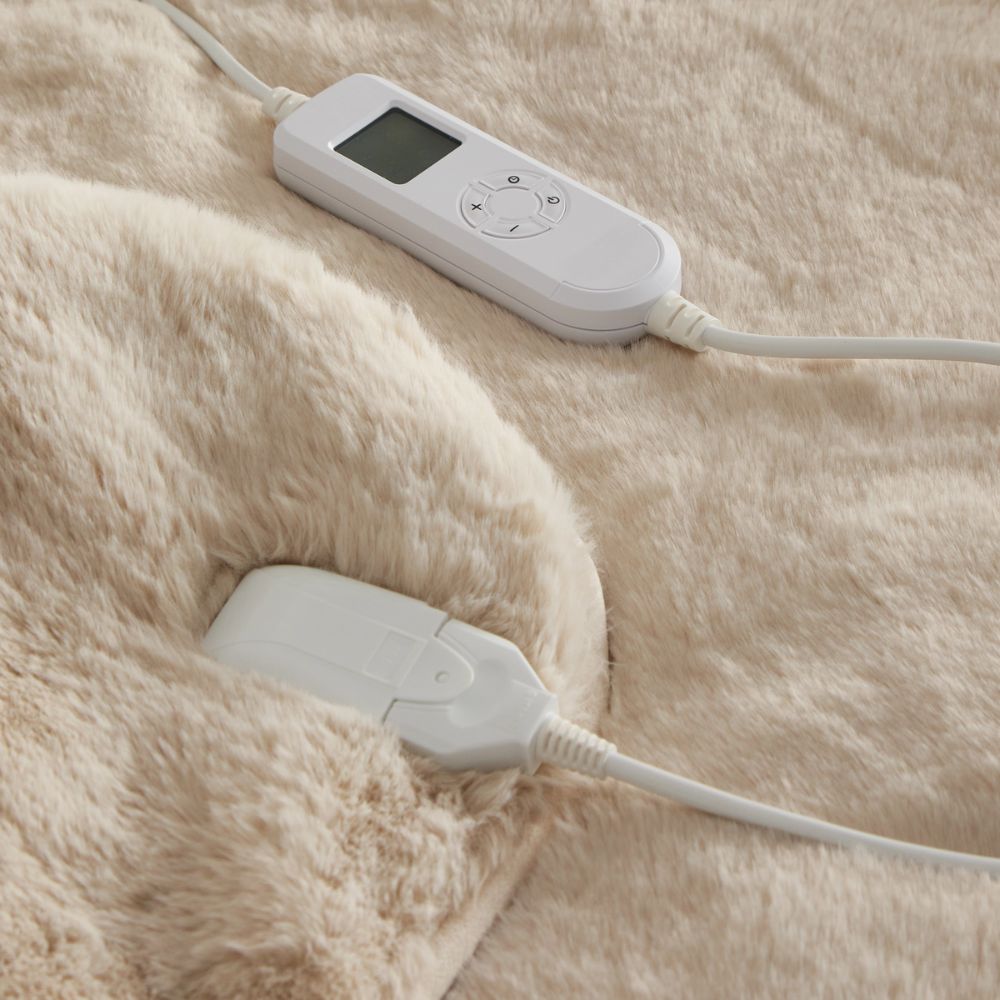 A beige faux fur throw with controls for heating
