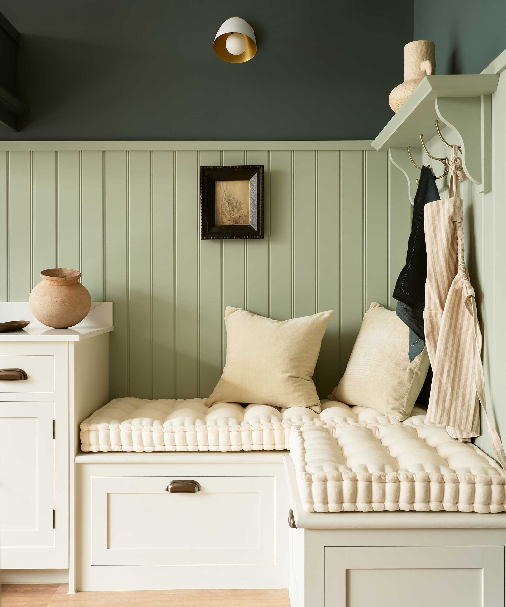 built-in seating nook in a Shaker-style pale green kitchen