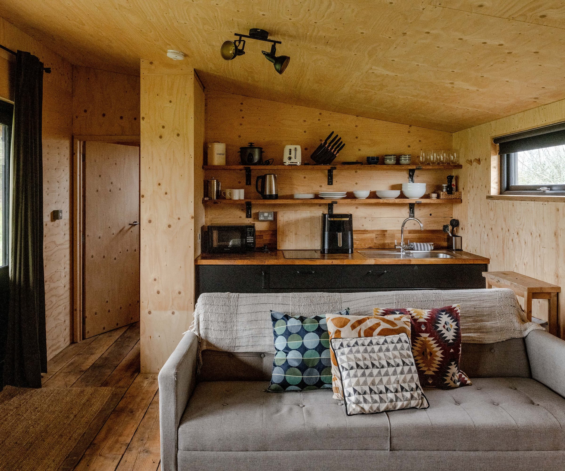 Inside an annexe with a sink and cooking area