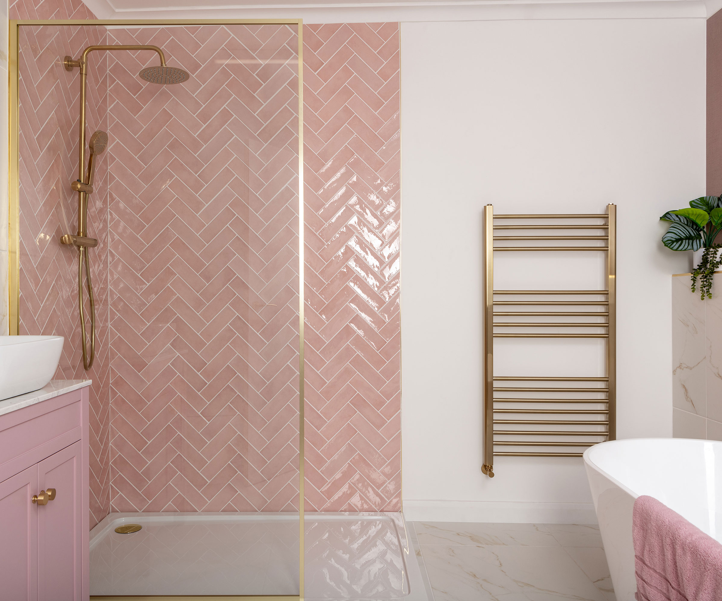 bathroom with walk-in shower and pink wall tiles