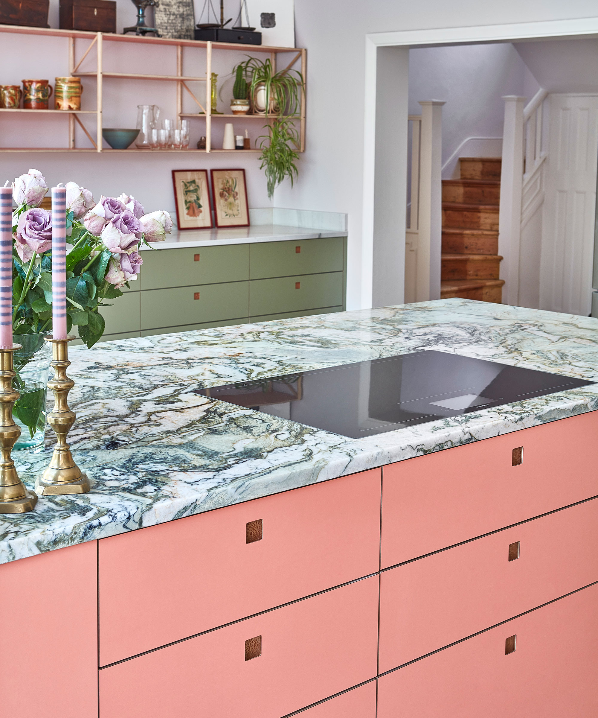 pink kitchen island with drawers and marble worktop