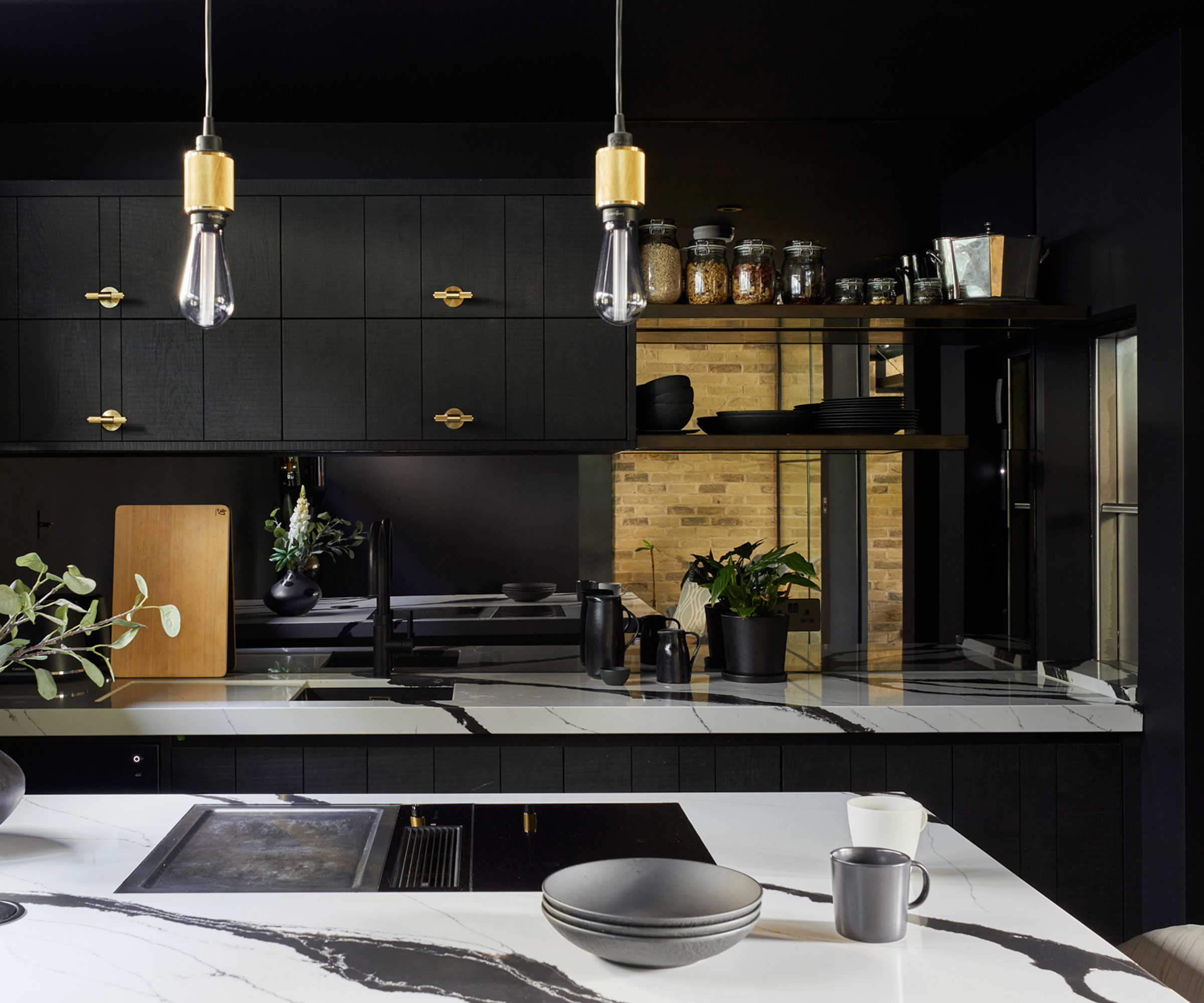small black kitchen with marble worktops