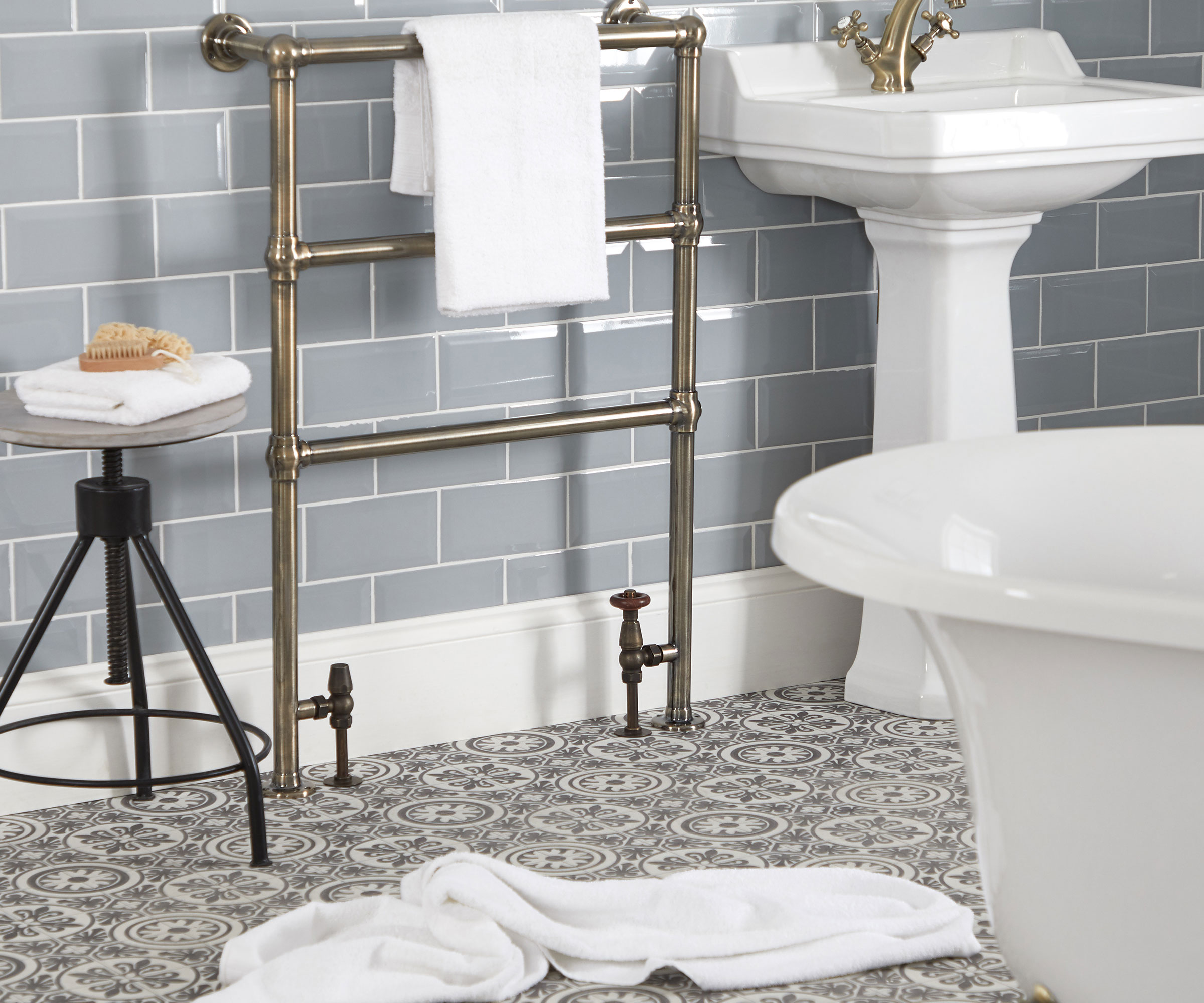 traditional heated towel rail in bathroom with rolltop bath