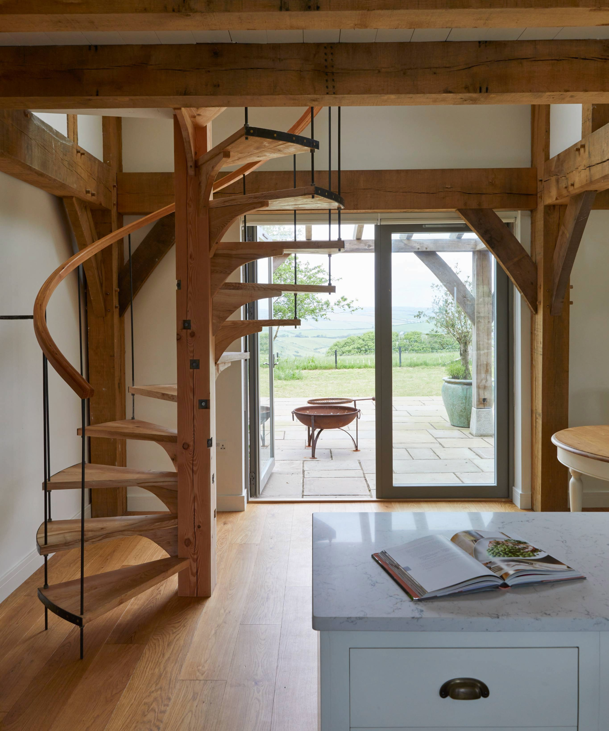 Spiral staircase to the left and doors opening onto veranda to the right